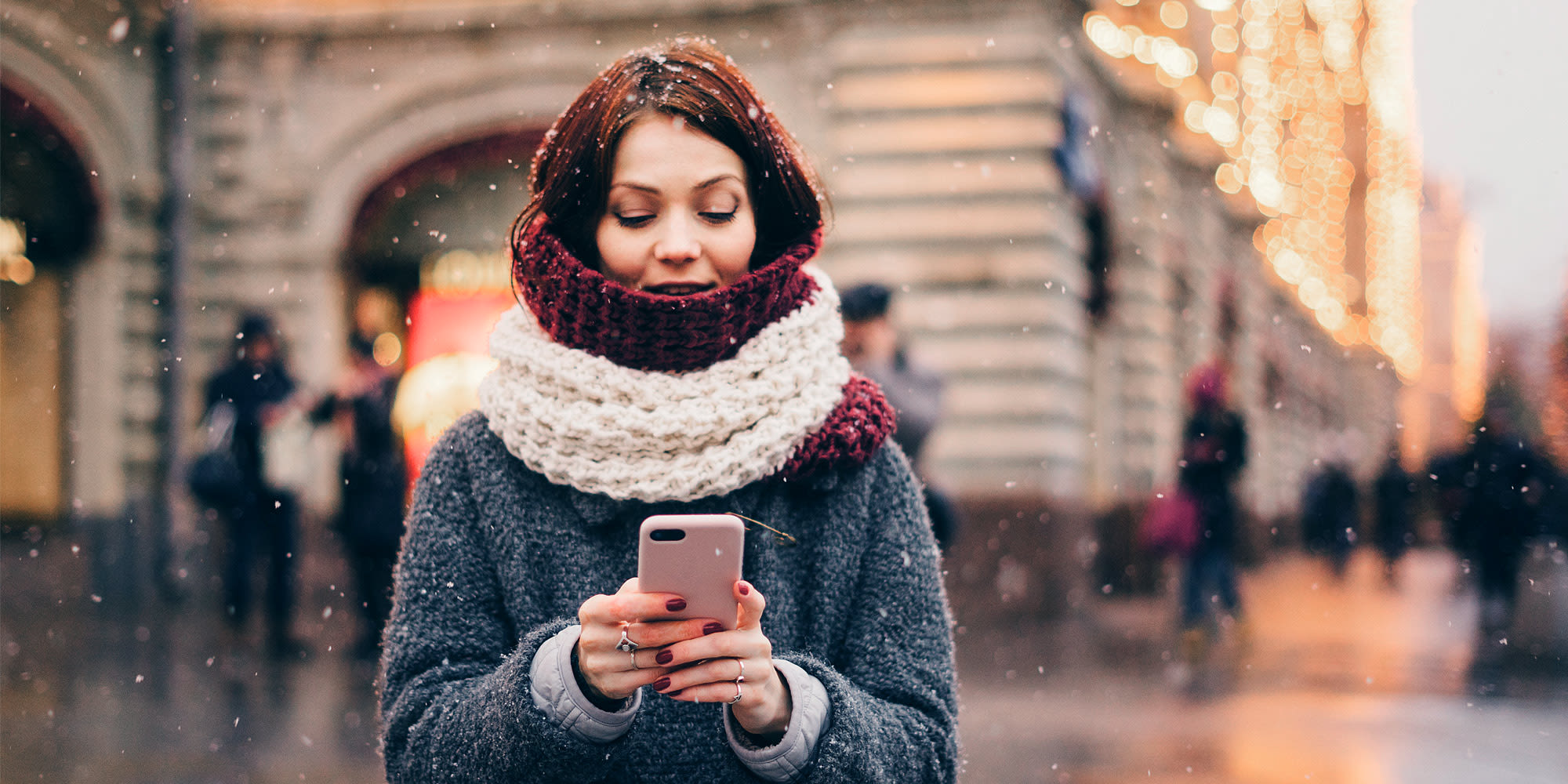 Woman holding a phone on street