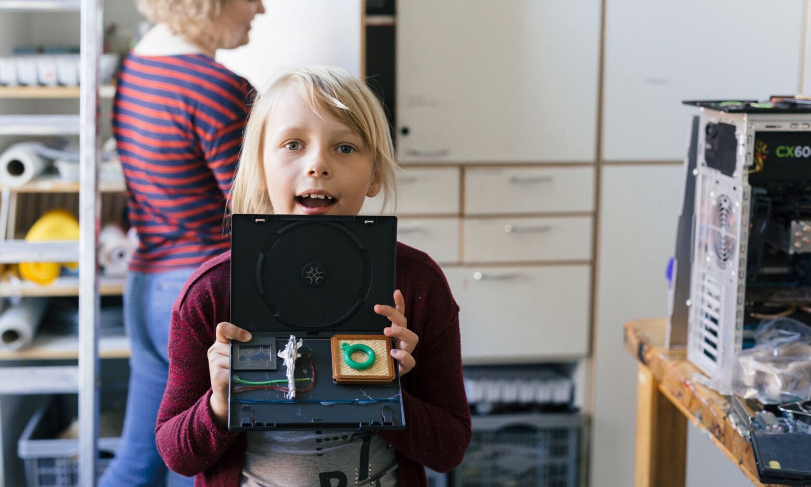 Lasten teknologialeirin osallistuja itsetehty tietokone käsissään.