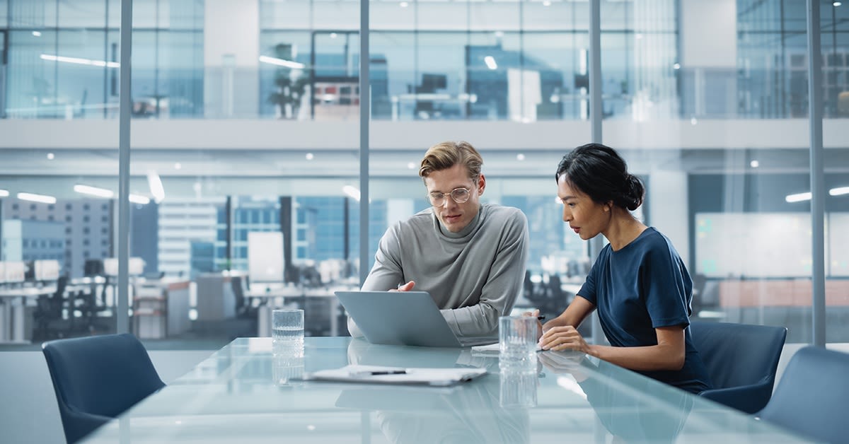 Azure-osaaminen. Asiantuntija katsoo tietokonetta asiakkaan kanssa.